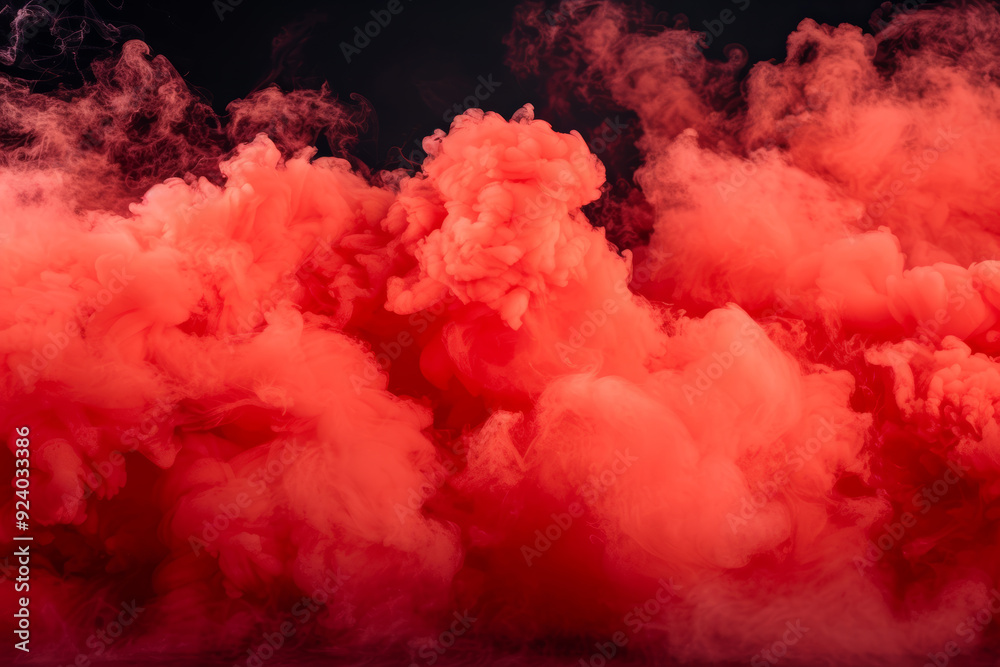 Fototapeta premium A dramatic burst of red smoke expands against a solid black background, creating a striking contrast. The swirling, cloud like formation captures the dynamic motion and intensity of the explosion.