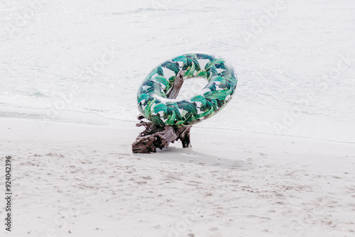 Palm leaf printed inner tube on the beach in the Caribbean.