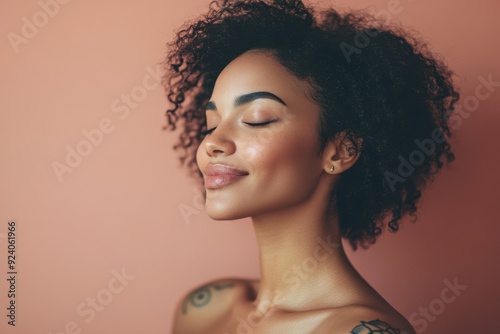 A close up of a woman's face with tattoos and her eyes closed