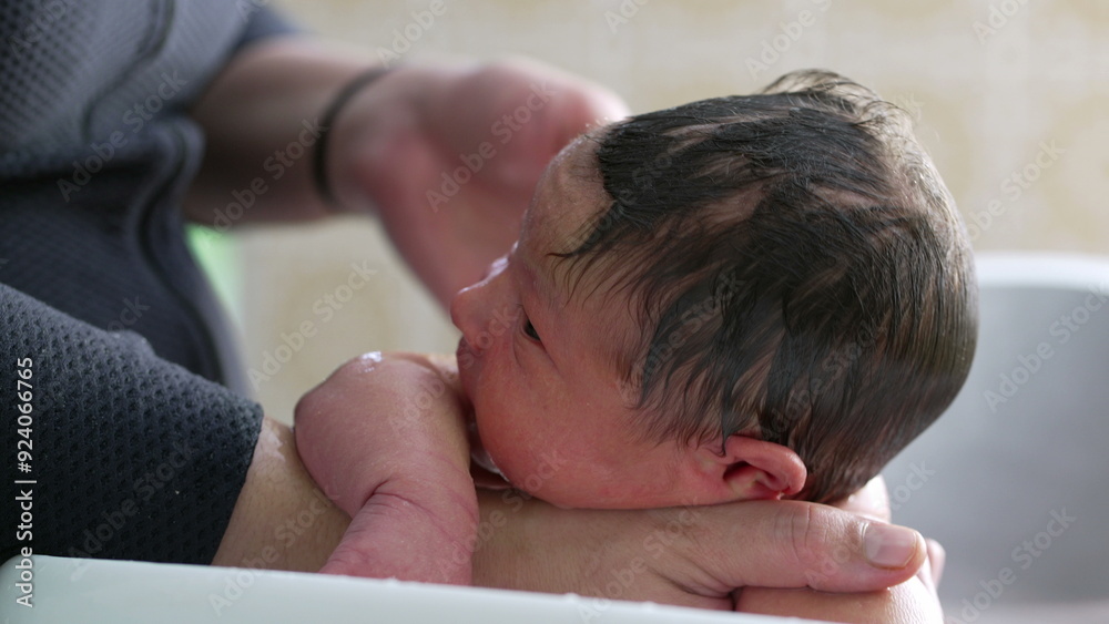 Close-up of a newborn baby during bath time, resting its head on the edge of the tub with a calm and curious expression, soothing and nurturing moments of early parenthood Close-up of a newborn baby during bath time, resting its head on the edge of the tub with a calm and curious expression, soothing and nurturing moments of early parenthood