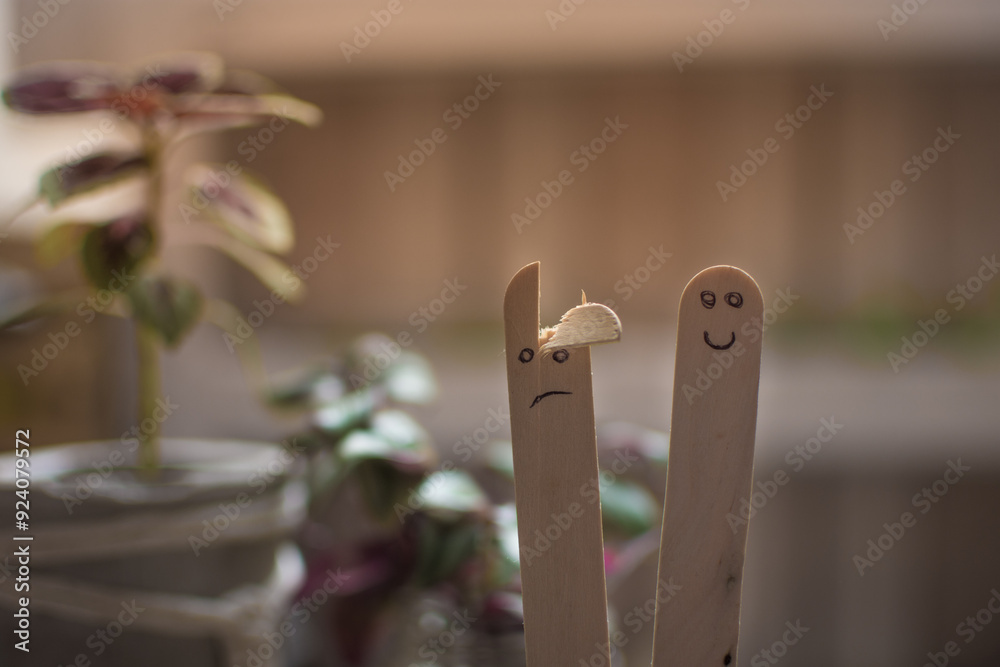 Faces drawn on ice cream sticks. Faces drawn on ice cream sticks.