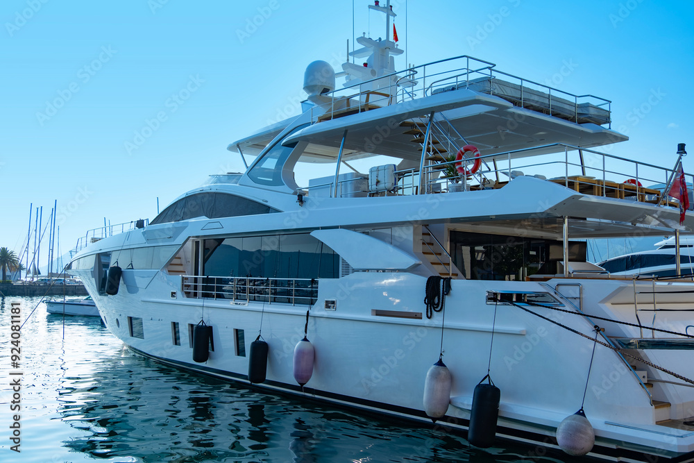 Naklejka premium white luxury yacht, motor both docked in marina, awaiting passengers for luxurious seaside vacation, maritime experience, ocean voyage, exclusive journey on open sea
