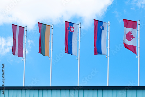 EU national flags flutter in wind, government Buildings, Space Agency, Parliament, Council Europe, Court of Justice, European Commission photo