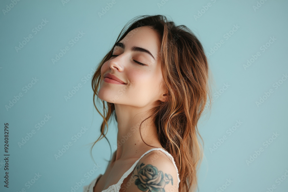 A close up of a woman's face with tattoos and her eyes closed