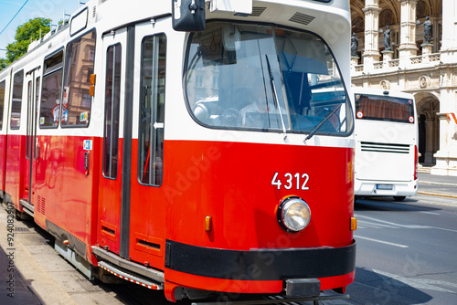 Iconic red tram, picturesque timeless elegance public transport, journey through city, linking rich past with dynamic present, Vienna, Austria