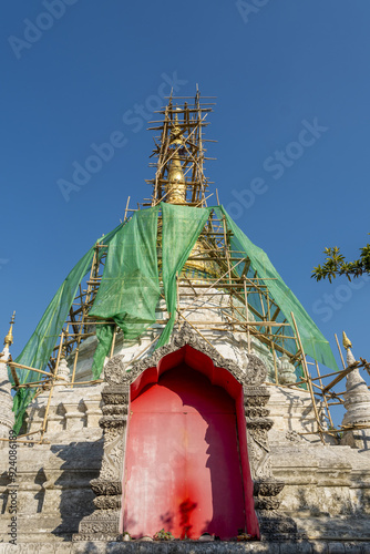 Bamboo scaffolding and work on the Burmese-style chedi in Wat Buppharam, Chiang Mai, Thailand	
 photo