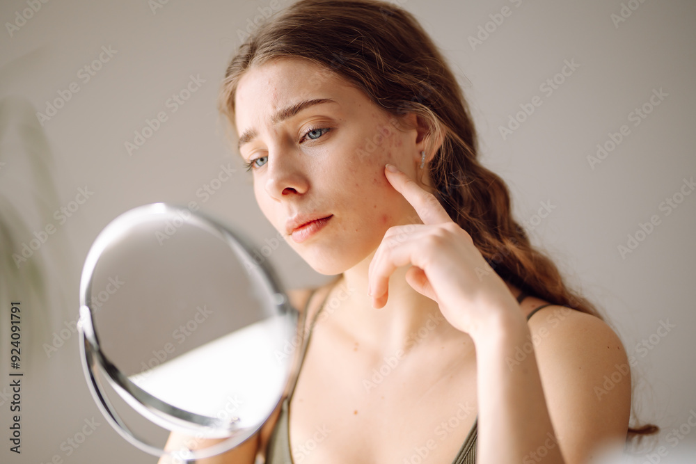 Ταπετσαρία Woman worry about her face when she saw the problem of acne occur by a mini mirror
