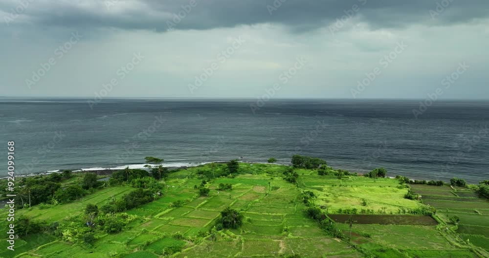 Stunning aerial view showcases a lush green coastal landscape below Stunning aerial view showcases a lush green coastal landscape below