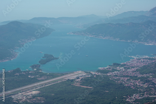 view from the top of the mountain on Kotor bay and Tivat airport in Montenegro on a sunny day.  Adriatic Sea Bay seen from mountains. photo