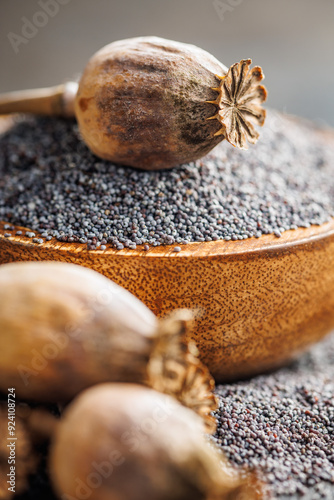 Dry head and poppy seed in bowl on kitchen table. photo