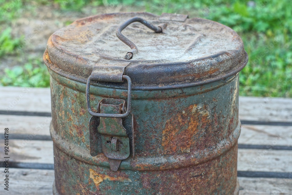 one round rusty retro iron closed old with lid industrial with handle and latches large container stands on wooden pallet daytime outdoors one round rusty retro iron closed old with lid industrial with handle and latches large container stands on wooden pallet daytime outdoors