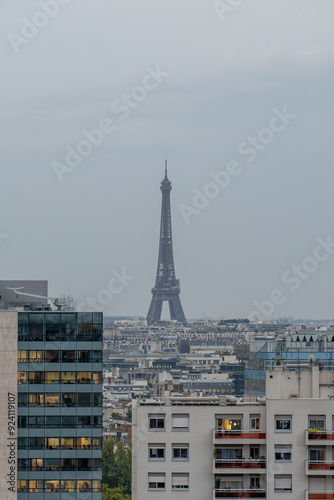 Distant view of the Eiffel Tower amidst the Parisian skyline on a cloudy day