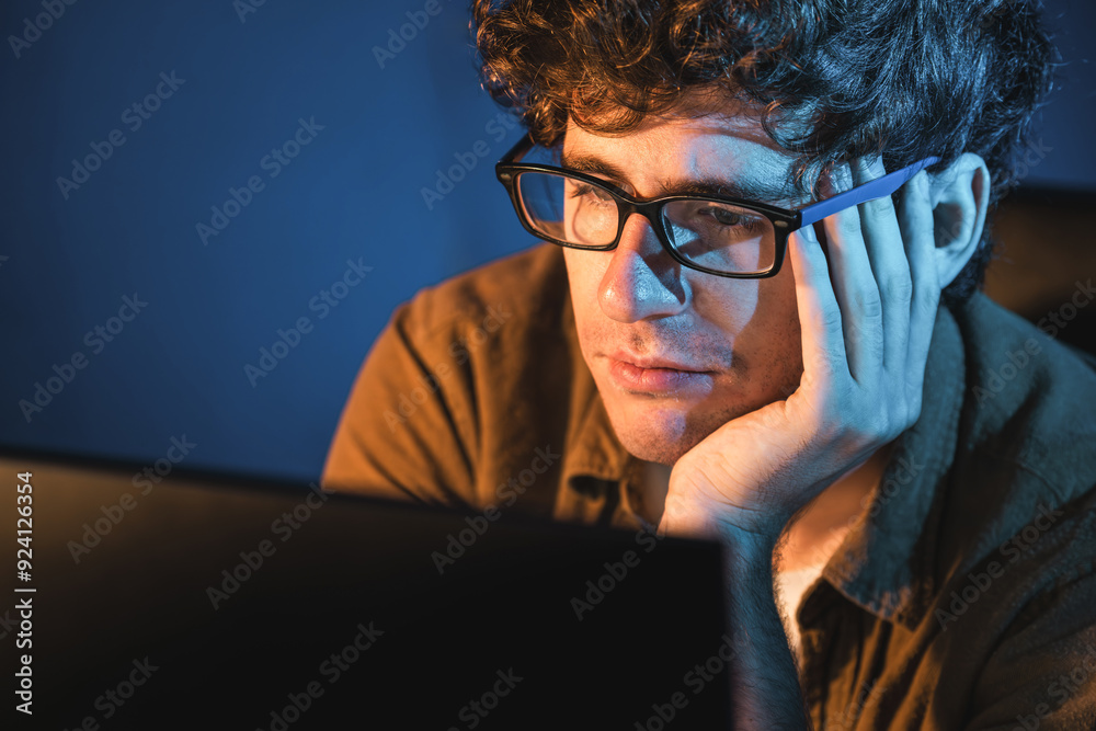 Stressful creative manager searching design thinking with new presentation while waiting email sending back on laptop screen at home office in casual shirt at neon light room at night time. Gusher. Stressful creative manager searching design thinking with new presentation while waiting email sending back on laptop screen at home office in casual shirt at neon light room at night time. Gusher.