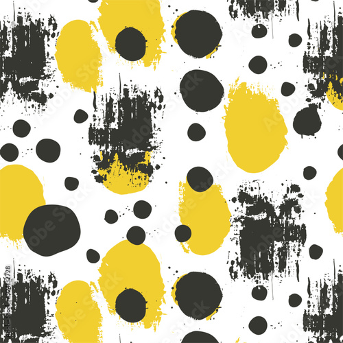 Seamless pattern with rough painted dots in black and yellow on white.
