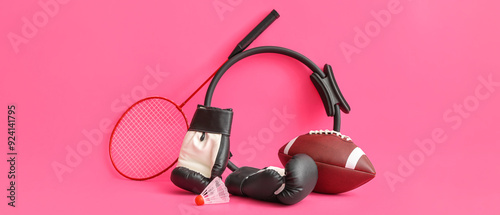 Different sports equipment on pink background