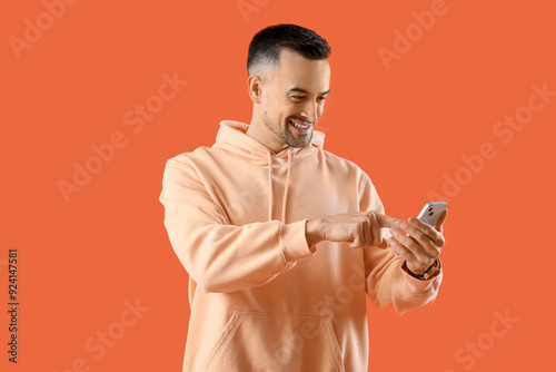 Happy young man using mobil...