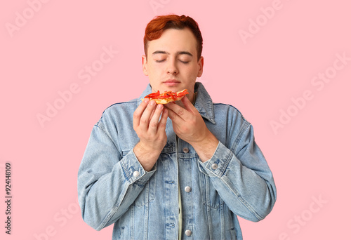 Young man eating piece of t...