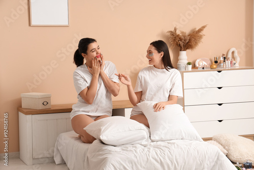 Happy young women with lip ...