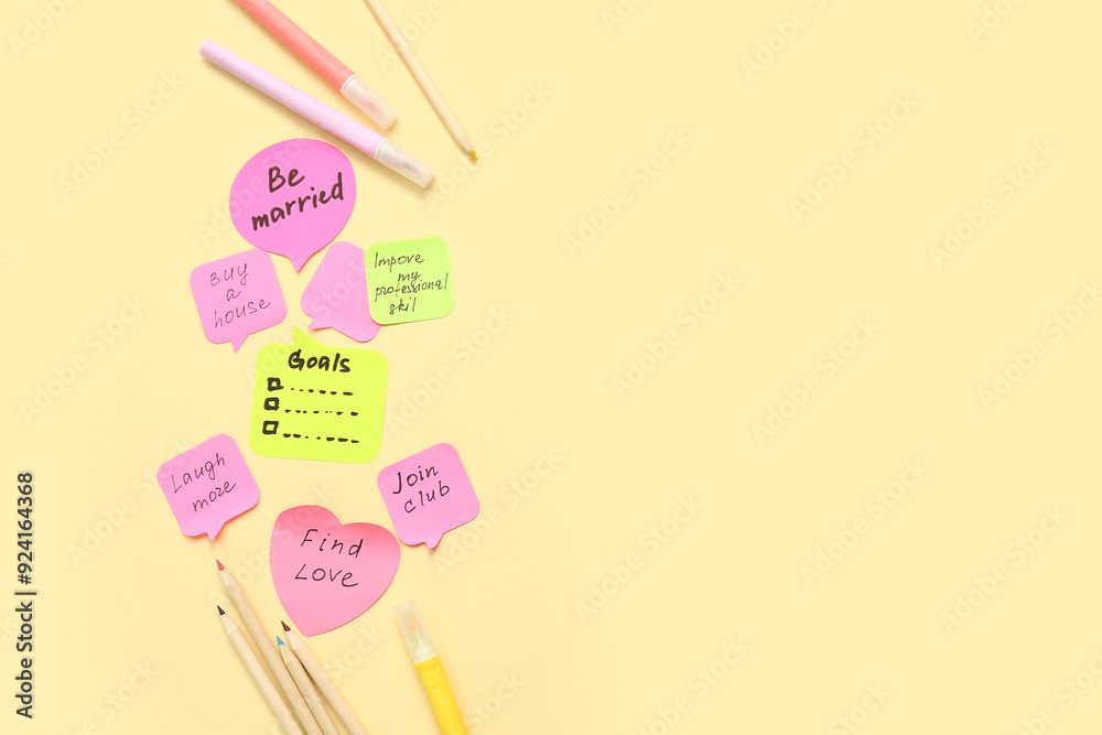 Sticky notes with to do plans and stationery on yellow background. New year goals concept Sticky notes with to do plans and stationery on yellow background. New year goals concept
