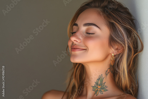 A close up of a woman's face with tattoos and her eyes closed