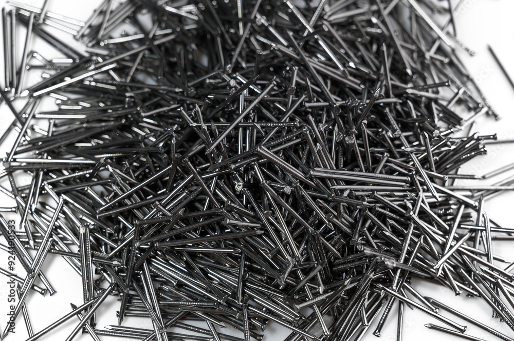 pile of black iron nails on white background with empty space pile of black iron nails on white background with empty space