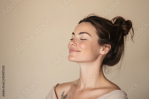 A close up of a woman's face with tattoos and her eyes closed