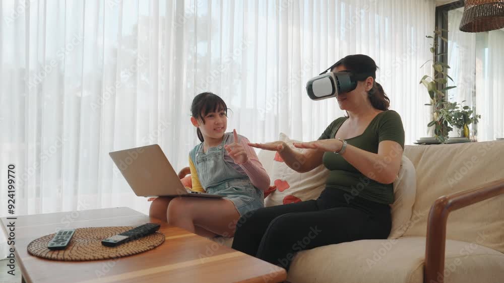 Granddaughter control laptop guide grandmother to dive in metaverse with VR. Senior adapt to technology activity communicate new generation kid cross generation gap strengthen family bond. Divergence. Granddaughter control laptop guide grandmother to dive in metaverse with VR. Senior adapt to technology activity communicate new generation kid cross generation gap strengthen family bond. Divergence.