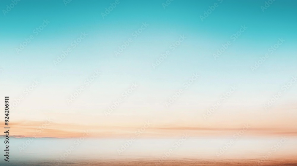 Fototapeta premium The sky at sunset transitions from turquoise to orange, creating a vibrant and peaceful scene. Perfect for a tranquil summer day