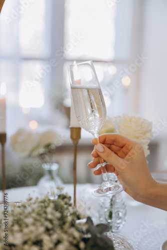 Champagne glasses Female hand holding in restaurant. Holidays Concept