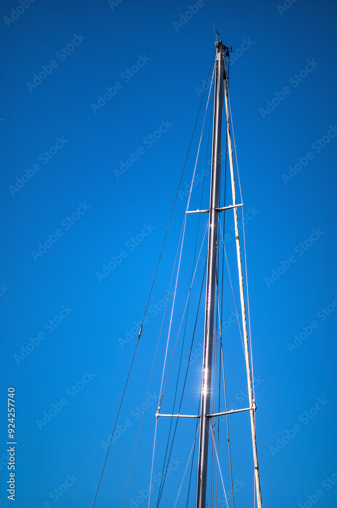Silver Sail Boat Mast with Sunlight Reflections. Silver Sail Boat Mast with Sunlight Reflections.