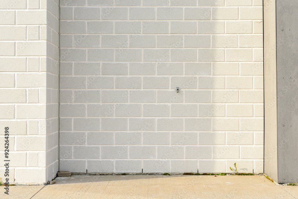 A light grey colored exterior brick wall with white mortar. The masonry ...