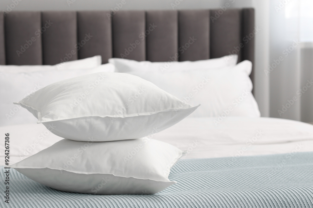 Many soft pillows on bed at home