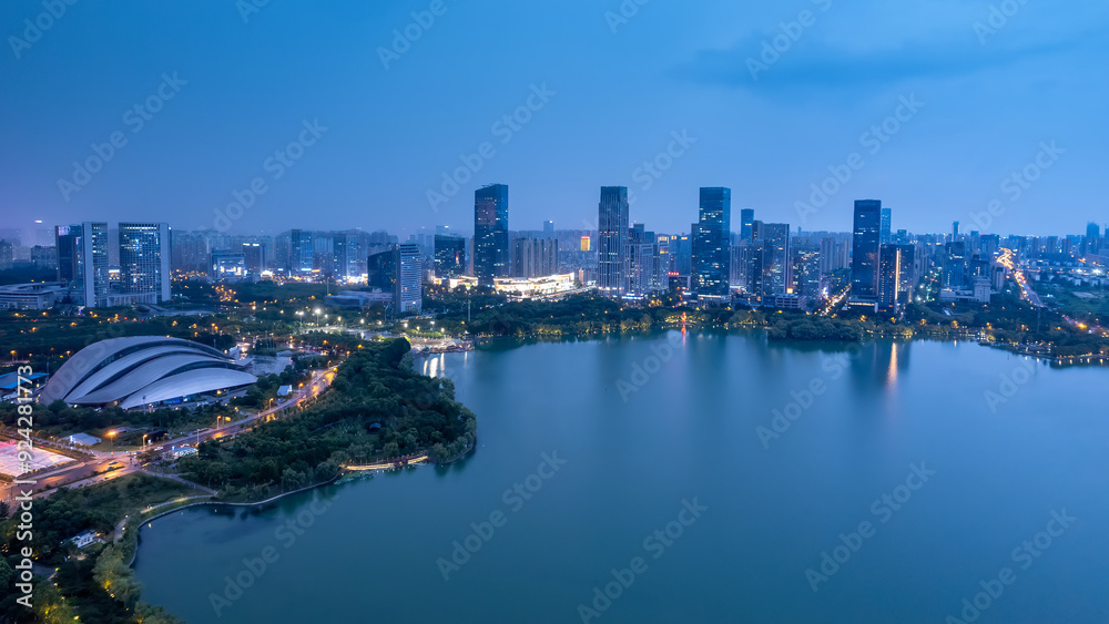 Naklejka premium Stunning Night View of a Modern Cityscape Reflected in Water