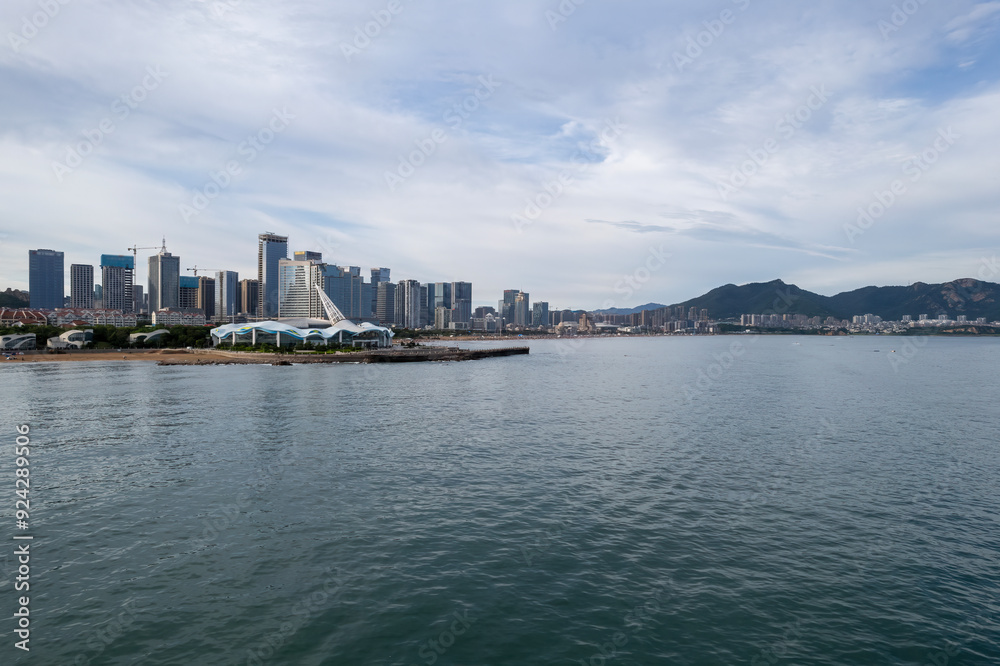 Serene Waterfront Cityscape with Modern Skyline and Mountains Serene Waterfront Cityscape with Modern Skyline and Mountains