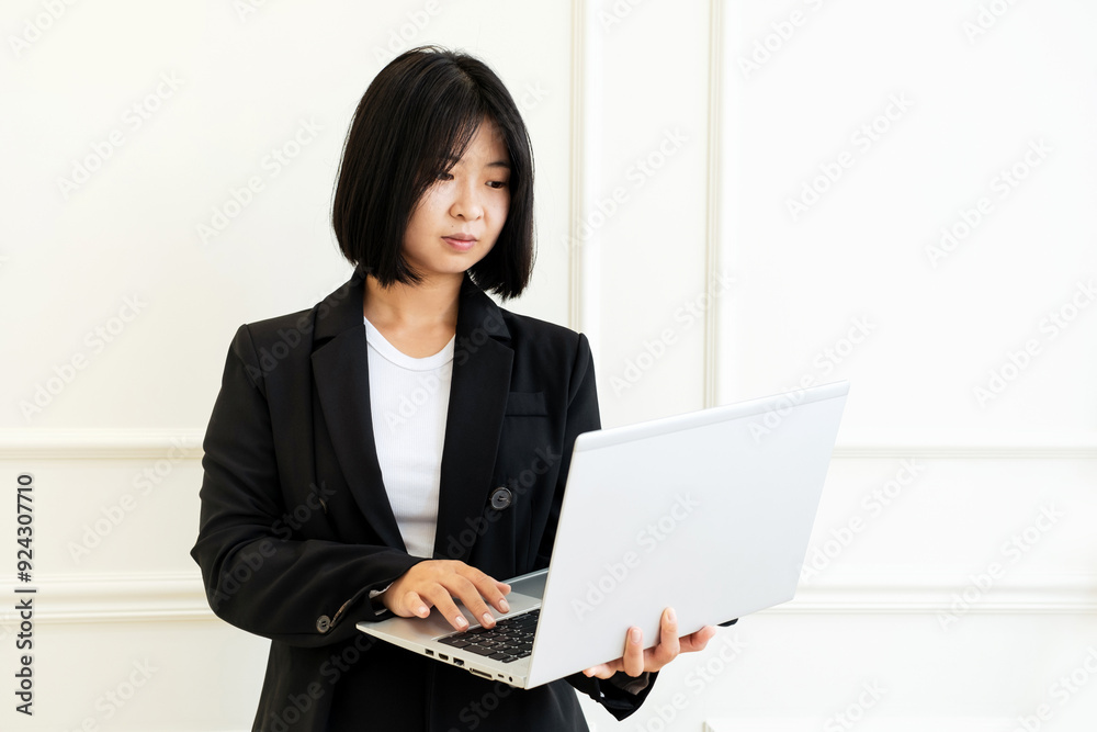 Young Asian woman with laptop on white background. Young Asian woman with laptop on white background.