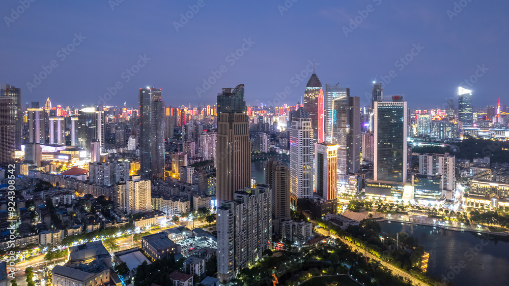Fototapeta premium Vibrant Nightscape of a Modern Urban Skyline Illuminated by City Lights
