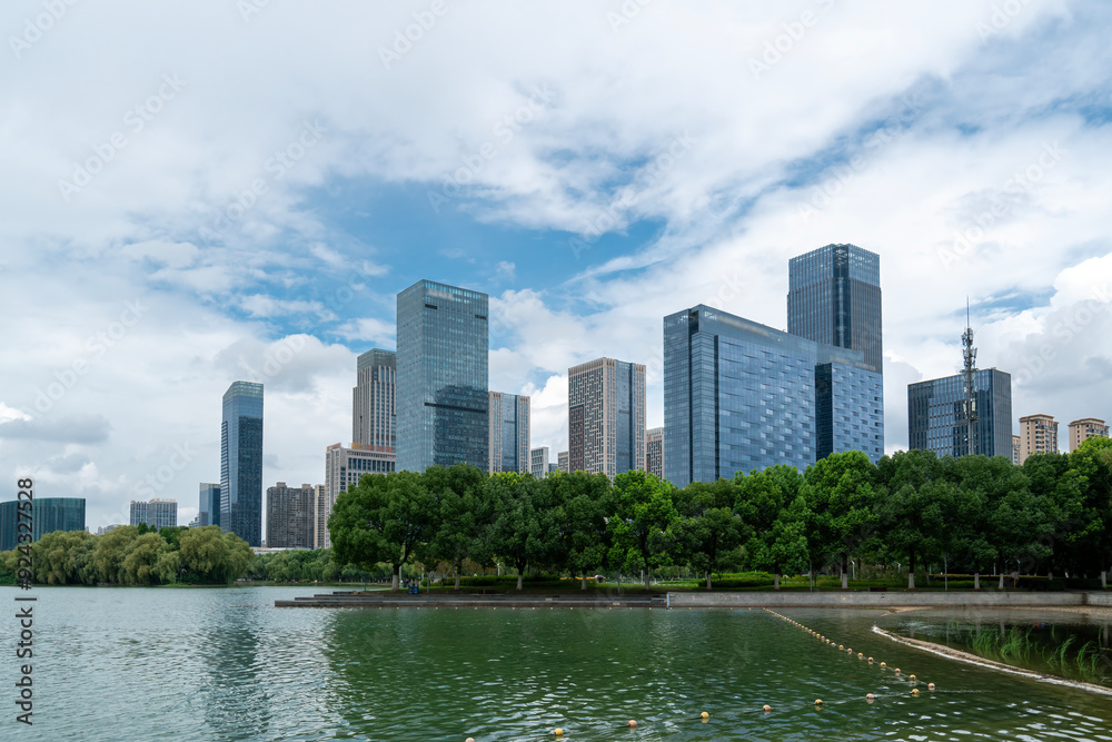 Modern Urban Skyline Reflected in a Serene Lake Modern Urban Skyline Reflected in a Serene Lake