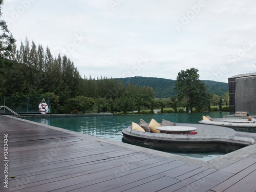 Outdoor swimming pool with sitting area surrounding by mountain and Pine of Kao Yai, Pak Chong District, Nakorn Ratchasima, Thailand.
