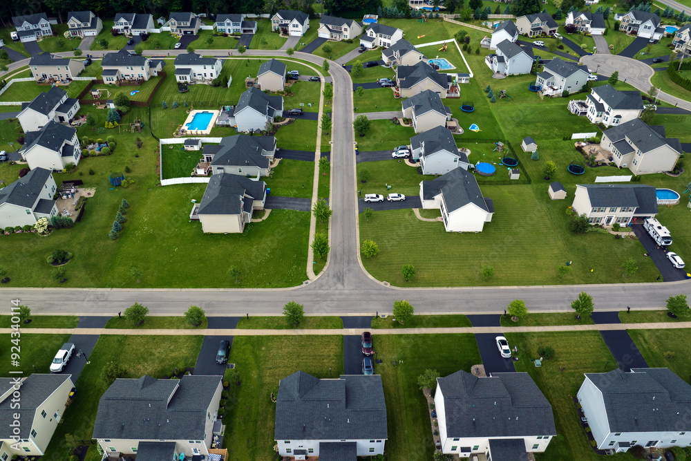 Obraz premium Low-density two story private homes in rural residential suburbs outside of Rochester, New York. Upscale suburban houses with large lot size and green grassy lawns in summer season