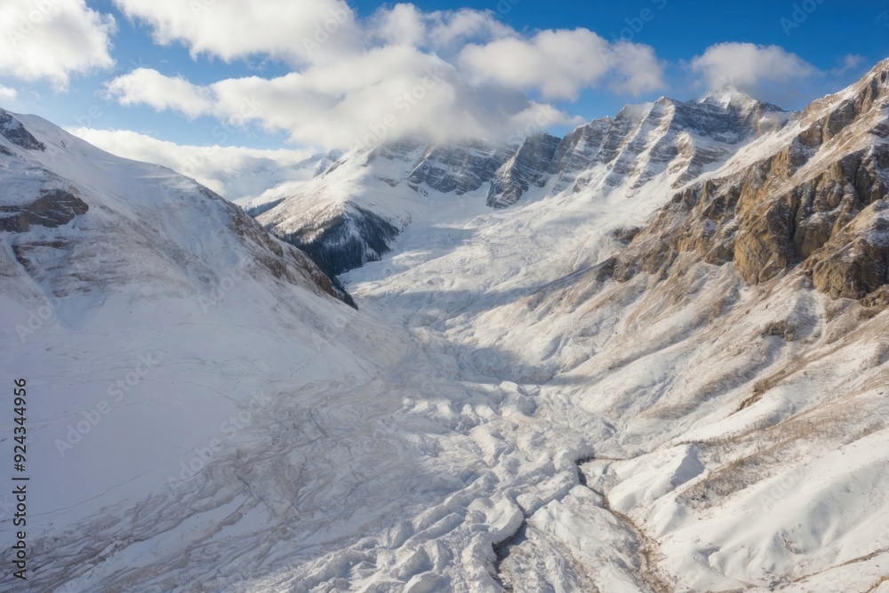 Obraz premium Avalanche Traces and Snow Debris in a Mountain Valley