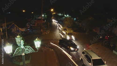 Bustling city nightlife with vibrant vehicle lights, capturing the energetic and lively essence of urban evening traffic