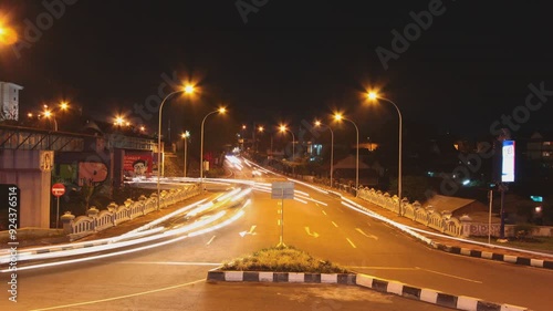 Bustling city nightlife with vibrant vehicle lights, capturing the energetic and lively essence of urban evening traffic.