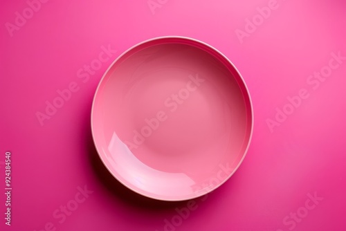 baby Pink plate isolated on a vibrant magenta background, top view 