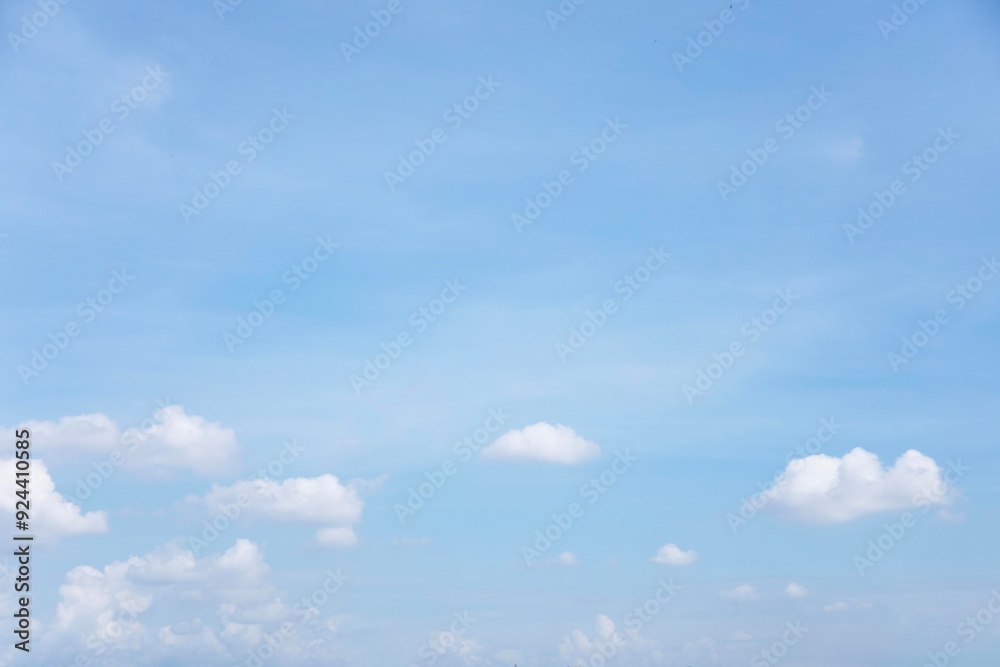 Blue sky background and white clouds soft focus, and copy space horizontal shape.