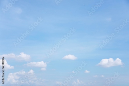Obraz na płótnie Blue sky background and white clouds soft focus, and copy space horizontal shape. w salonie
