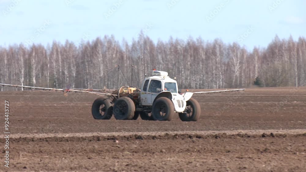 Chemical treatment with agricultural machines before spraying. Tractor spraying pesticides on field with sprayer.
Chemical treatment with agricultural machines before spraying. Tractor spraying pesticides on field with sprayer.