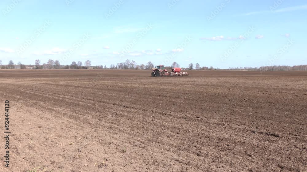 Tractor drilling seeding crops at farm. Agricultural activity. A tractor sows a field with grain. Close-up of a seeder.
Tractor drilling seeding crops at farm. Agricultural activity. A tractor sows a field with grain. Close-up of a seeder.