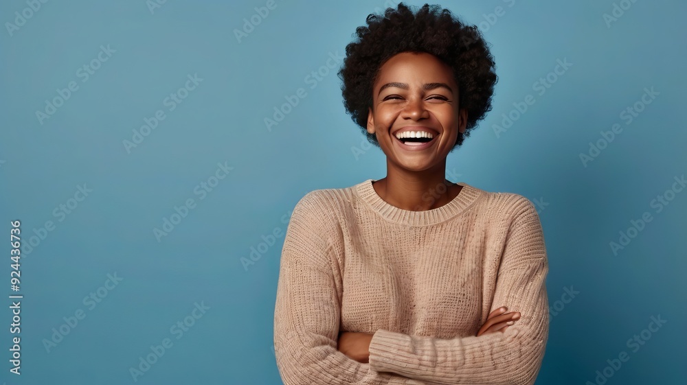 Photo of delighted cheerful Afro American woman with crisp hair, points away, shows blank space, happy to advertise item on sale, wears orange jumper