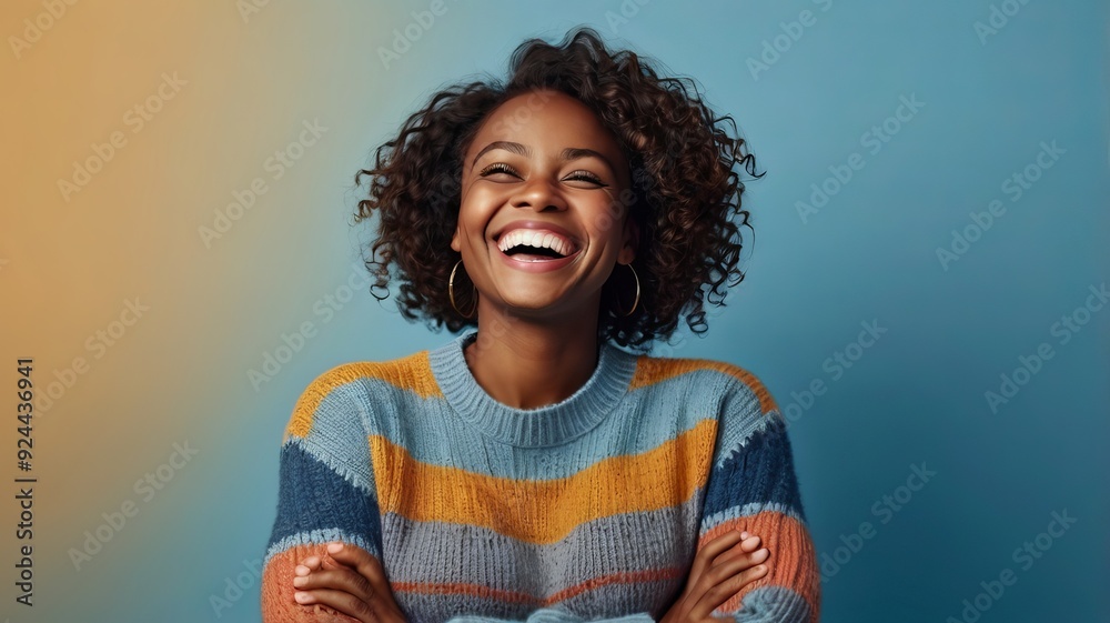 Photo of delighted cheerful Afro American woman with crisp hair, points away, shows blank space, happy to advertise item on sale, wears orange jumper