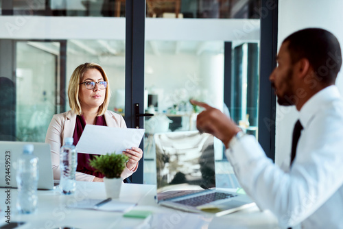 Business people, documents and meeting with discussion for company report, finance or budget at office. Young businessman and woman discussing paperwork for financial growth on revenue or improvement